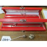 Two cased sets of Sterling chopsticks with rests and a rickshaw