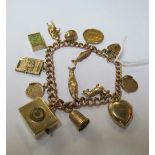 A 9ct gold charm bracele padlock clasp,music box charm playing happy birthday,mounted half sovereign