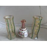 A pair of vases with gilt floral design and green banding and red and opaque white vase (odd