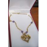 A heart pendant on amethyst inset chain marked 14k