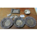 Three silver wine labels and decorative metal dishes