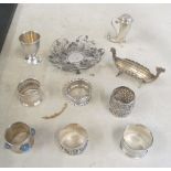 Some silver and white metal napkin rings, silver egg cup, pepperette, Danish salt, bon bon et cetera