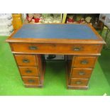 A twin pedestal desk with brass military style handles