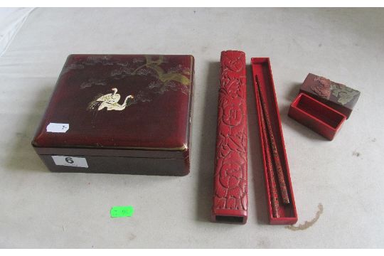 An oriental box decorated cranes, red lacquer box with chopsticks and another box