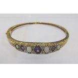 A 9ct gold bangle set amethysts, opals and diamond chips 13.7g
