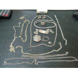 A silver identity bracelet, ring, silver patch box and various chains