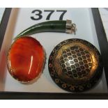 A gold and tortoishell brooch, yellow metal and orange agate brooch and a green agate pendant