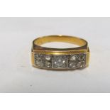 A diamond ring with central stone and eight small stones marked 750 6.2g