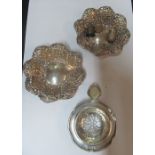 A pair of pierced silver bon bon dishes, silver tea strainer and three silver thimbles