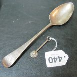 A silver spoon and silver skewer in stand