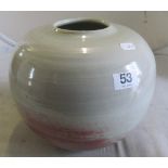 A Celadon style oriental spherical vase with red streaking