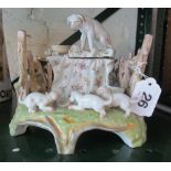 An ornate porcelain inkwell with dog to top