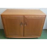 An Ercol Golden Dawn small sideboard two cupboard doors