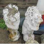 A pair of white painted stoneware garden statues lions