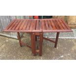 A teak gate leg garden table and four chairs