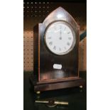 An Edwardian arch top mantel clock with satinwood and ebony banding