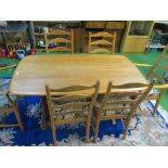 An Ercol Golden Dawn dining table and six ladder backchairs