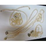 A three strand pearl necklace with clasp marked 585, pearl necklace with flowerhead clasp and