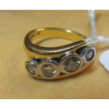 An 18ct gold four stone diamond ring