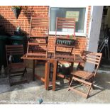 A teak gate leg garden table and four chairs