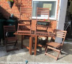 A teak gate leg garden table and four chairs