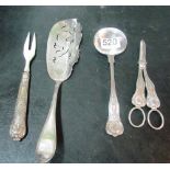 A pair of plated grape scissors, spoon, server and fork