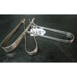 A pair of Georgian silver tongs and two others 3.1 ozs