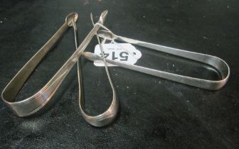 A pair of Georgian silver tongs and two others 3.1 ozs