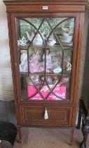 An Edwardian single door cabinet with drop down cupboard