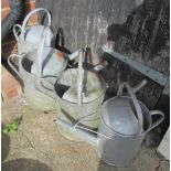 Four galvanised watering cans