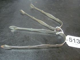 A pair of Georgian silver tongs engraved design 2 ozs