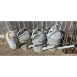 Four galvanised watering cans