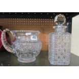 A decanter and a cut glass jug