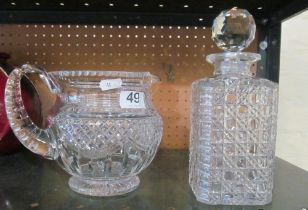 A decanter and a cut glass jug