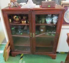 An oriental two door display cabinet