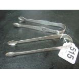 A pair of Georgian silver sugar tongs and another 1.8 ozs