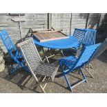 A garden table and 6 chairs some part painted blue