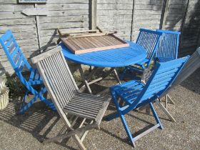 A garden table and 6 chairs some part painted blue