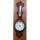 An oak cased barometer/thermometer