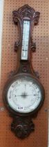 An oak cased barometer/thermometer