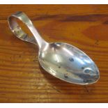 A silver caddy spoon with plain bowl