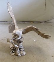 A hallmarked silver resin filled eagle on stand (wing repaired)