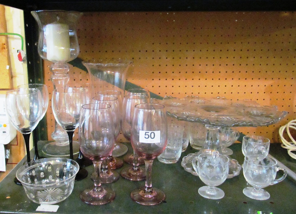 A glass celery vase, candleholder and other glass