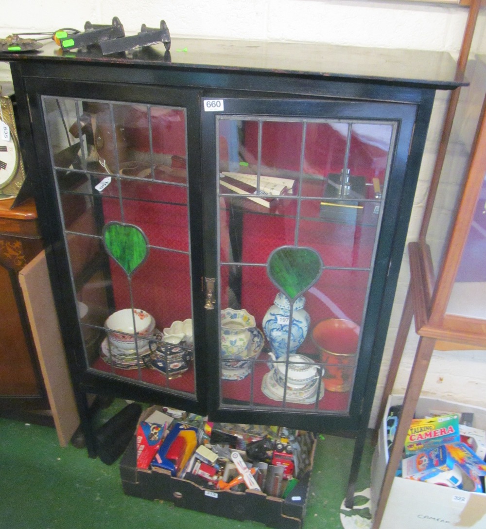 An Edwardian mahogany display cabinet with stained glass door