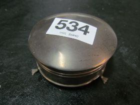 A small circular silver ring box