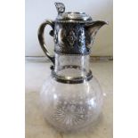 A claret jug with silver neck and lid