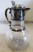 A claret jug with silver neck and lid