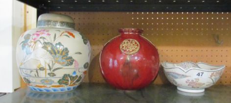 A modern oriental ginger jar decorated storks, red glazed spherical vase and bowl decorated birds