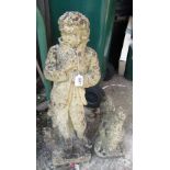 A stoneware garden statue of a boy and another cockrell