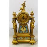 A 19th Century gilt French mantel clock with decorative panels, caryatid columns and cherub to top